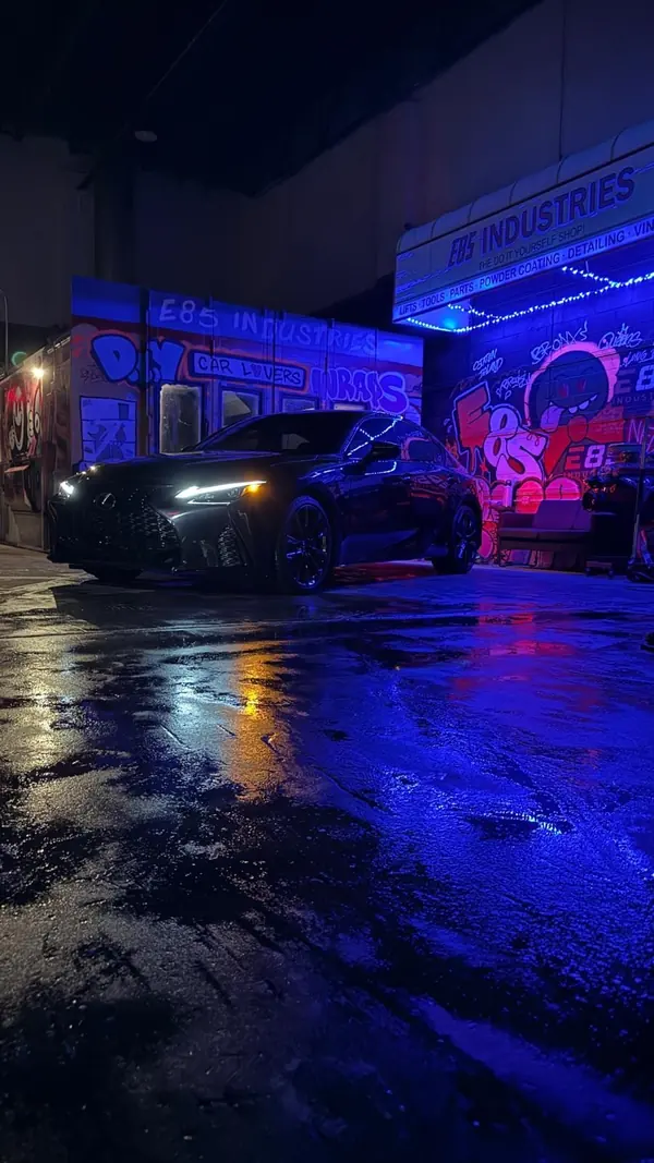 Lexus IS sedan at night after detailing